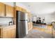 Bright kitchen with stainless steel refrigerator, granite countertops, and adjoining dining area at 1516 Cumberland Rd, Chapel Hill, NC 27514