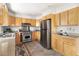 Well-lit kitchen featuring stainless steel appliances, granite countertops, and light wood cabinetry at 1516 Cumberland Rd, Chapel Hill, NC 27514