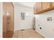 Utility room with a wall of storage cabinets, washer/dryer hookups and a neutral color palette at 1516 Cumberland Rd, Chapel Hill, NC 27514