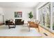 Light-filled living room featuring hardwood floors, modern furniture, and large windows with natural views at 1516 Cumberland Rd, Chapel Hill, NC 27514