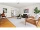 Bright living room with hardwood floors, stylish furnishings, and a view to an office at 1516 Cumberland Rd, Chapel Hill, NC 27514