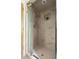 Tiled walk-in shower with glass door and built-in niche at 1516 Cumberland Rd, Chapel Hill, NC 27514