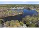 Overhead view of a lakeside neighborhood, featuring charming homes nestled among vibrant trees and sparkling waters at 155 Chimney Rise Dr, Cary, NC 27511