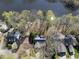 Drone shot of homes near the water's edge surrounded by mature trees and landscaping at 155 Chimney Rise Dr, Cary, NC 27511