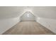 Spacious attic area with carpet, white walls, sloped ceilings, and a window at 155 Chimney Rise Dr, Cary, NC 27511