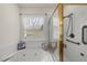 Bathroom with a relaxing whirlpool tub, separate glass shower, and natural light streaming through the window at 155 Chimney Rise Dr, Cary, NC 27511