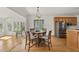 A dining area includes a table and view into a kitchen with stainless appliances at 155 Chimney Rise Dr, Cary, NC 27511