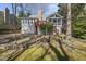 The rear exterior features a screened-in porch, a spacious deck, and lush landscaping at 155 Chimney Rise Dr, Cary, NC 27511