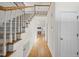Bright foyer featuring hardwood floors, a staircase, and views into the living area at 155 Chimney Rise Dr, Cary, NC 27511