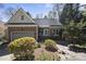 Charming brick home featuring a well-manicured lawn, an attached garage, and a cozy front porch at 155 Chimney Rise Dr, Cary, NC 27511