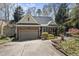A charming brick home featuring a well-maintained yard and attached garage at 155 Chimney Rise Dr, Cary, NC 27511