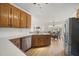 Open kitchen with wooden cabinets, stainless steel appliances, and a view into the dining area at 155 Chimney Rise Dr, Cary, NC 27511