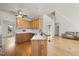 A kitchen with light wood cabinets and stainless steel appliances is attached to an open floorplan at 155 Chimney Rise Dr, Cary, NC 27511