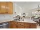 Shows the kitchen with oak cabinets, stainless steel appliances, and a double sink at 155 Chimney Rise Dr, Cary, NC 27511