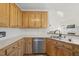 Shows the kitchen with oak cabinets, stainless steel appliances, and a double sink at 155 Chimney Rise Dr, Cary, NC 27511