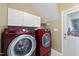 Efficient laundry room with front-load washer and dryer, storage cabinets, and a clean, functional design at 155 Chimney Rise Dr, Cary, NC 27511