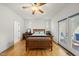 Bright and airy main bedroom boasts hardwood floors, ceiling fan, and access to an outdoor space at 155 Chimney Rise Dr, Cary, NC 27511