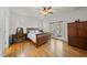Sun-filled main bedroom features hardwood floors, ceiling fan, and access to an outdoor deck at 155 Chimney Rise Dr, Cary, NC 27511