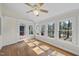Bright sunroom featuring hardwood floors, multiple windows with scenic views, and convenient access to the outdoors at 155 Chimney Rise Dr, Cary, NC 27511