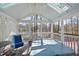 Sunroom featuring a spa, wooden deck, ceiling fan, skylights, and scenic outdoor views at 155 Chimney Rise Dr, Cary, NC 27511