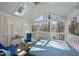 Relaxing sunroom featuring a spa, ceiling fan, skylights, and scenic lakeside views at 155 Chimney Rise Dr, Cary, NC 27511