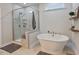 Luxurious bathroom featuring a modern soaking tub, a separate shower, and stylish decor at 16 Blue Monarch Ln, Fuquay Varina, NC 27526