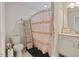 Cozy bathroom featuring a toilet, a sink, a shower with curtain, and modern fixtures at 16 Blue Monarch Ln, Fuquay Varina, NC 27526