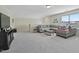 Spacious bonus room featuring plush gray carpeting and a comfortable sectional sofa at 16 Blue Monarch Ln, Fuquay Varina, NC 27526