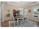 Charming dining room with a modern chandelier, a large table with seating for six, and natural light at 16 Blue Monarch Ln, Fuquay Varina, NC 27526