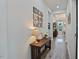 Inviting hallway with stylish decor and wood floors, leading to a dining area with natural light at 16 Blue Monarch Ln, Fuquay Varina, NC 27526