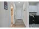 Hallway with laundry room and bathroom access, with views of stylish decorations and a utility area at 16 Blue Monarch Ln, Fuquay Varina, NC 27526
