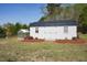 White outbuilding with dark metal roof, nestled in landscaped yard at 16 Blue Monarch Ln, Fuquay Varina, NC 27526