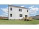 A large, green backyard with a wood deck attached to the back of the house, great for relaxing at 163 Fair Child Rd, Spring Lake, NC 28390