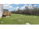 Large, grassy backyard with partial landscaping and a wood deck off the house, good for relaxing at 163 Fair Child Rd, Spring Lake, NC 28390