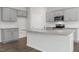 Well-equipped kitchen with a central island, granite counters, and sleek gray cabinetry at 163 Fair Child Rd, Spring Lake, NC 28390