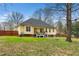 View of the home's exterior and sprawling, partially-wooded backyard at 1638 Crystal Ln, Stem, NC 27581