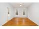 Bright bedroom features hardwood floors and a ceiling fan at 1638 Crystal Ln, Stem, NC 27581