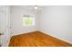 Bedroom features hardwood floors, a window, and closet at 1638 Crystal Ln, Stem, NC 27581