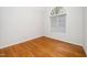 Bright bedroom features hardwood floors and large arched window, creating a welcoming space at 1638 Crystal Ln, Stem, NC 27581