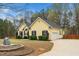 Exterior shot of the home shows the front and side, with a large yard and landscaping at 1638 Crystal Ln, Stem, NC 27581