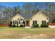 Charming yellow ranch-style home with well-maintained landscaping and a classic design at 1638 Crystal Ln, Stem, NC 27581