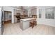 Open kitchen with gray cabinets, stainless appliances, and a breakfast bar area at 1638 Crystal Ln, Stem, NC 27581