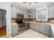 Modern kitchen featuring gray cabinetry, stainless steel appliances, and tile flooring at 1638 Crystal Ln, Stem, NC 27581