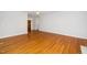 Spacious living room featuring gleaming hardwood floors and plenty of natural light at 1638 Crystal Ln, Stem, NC 27581