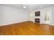 Bright living room with a fireplace, hardwood floors, and a ceiling fan at 1638 Crystal Ln, Stem, NC 27581