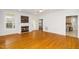 Open living area with fireplace, hardwood floors, and access to the kitchen at 1638 Crystal Ln, Stem, NC 27581