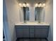 Modern bathroom featuring double sinks, white countertops, vanity and ample lighting at 168 Bruce Dr, Dunn, NC 28334