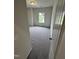 A well lit bedroom with view of green space, carpet, and neutral walls at 168 Bruce Dr, Dunn, NC 28334