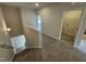 Hallway featuring carpeted staircase and second floor laundry room at 168 Bruce Dr, Dunn, NC 28334