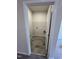 Convenient second-floor laundry room with tile flooring and shelving at 168 Bruce Dr, Dunn, NC 28334